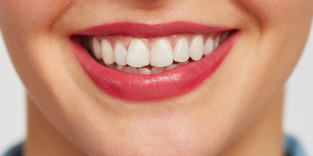 Blog 9 Close-up shot of female face with charming toothy smile against white background
