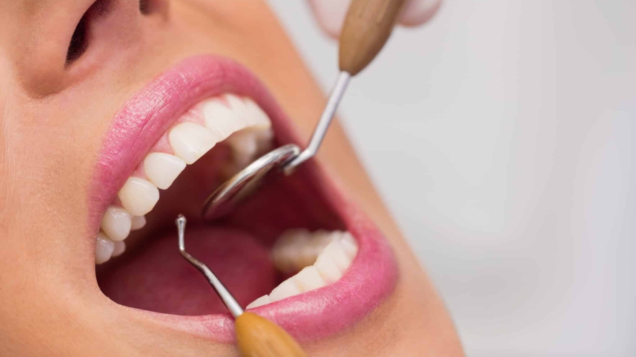 Close up of dentist examining female patient teeth