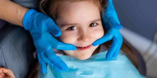 Blog 14 child-with-blue-gloves-is-getting-her-teeth-checked