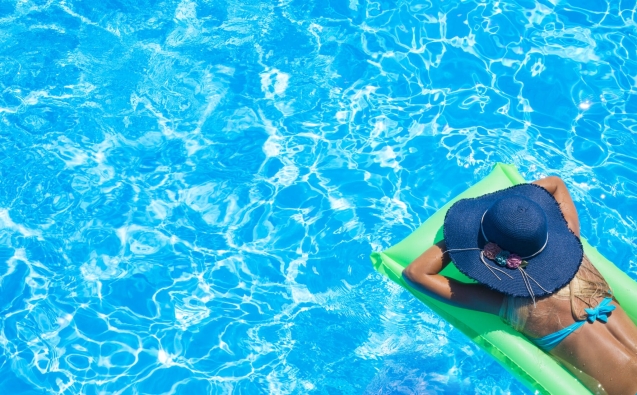 Dental Clinic 3 Top view of slim young woman in bikini on the green air mattress in the swimming pool.